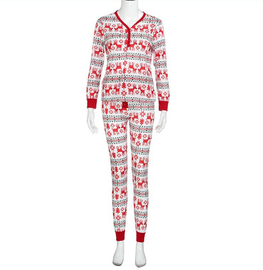 Family of four and a dog wearing matching long-sleeved Christmas pajamas with red reindeer and green snowflake print. - Image 8