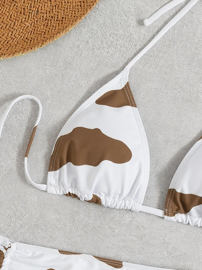Women's three-piece cow print swimsuit with a white and brown triangle bikini top and a ruched mini skirt. - Image 12