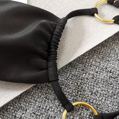 Solid black two-piece swimsuit set with a bandeau top, gold-tone O-rings, and tie straps, paired with matching thong bottoms. - Image 12