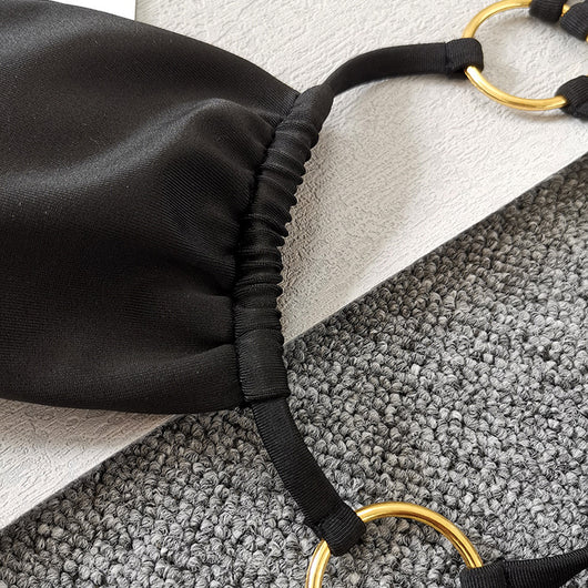 Solid black two-piece swimsuit set with a bandeau top, gold-tone O-rings, and tie straps, paired with matching thong bottoms. - Image 12