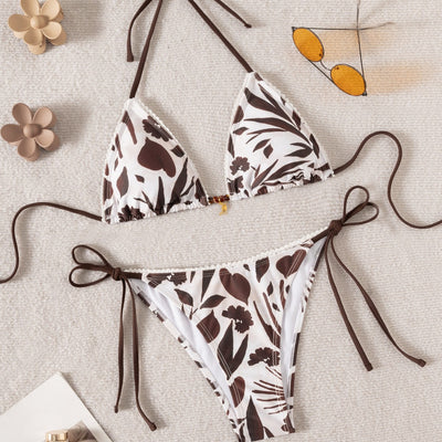 Brown and white floral print triangle bikini with tie-side bottoms and a small gold pendant detail. - Image 4