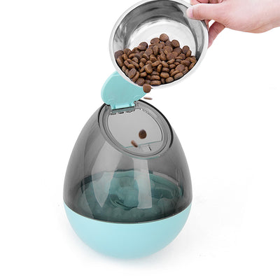 Orange and blue interactive pet food dispenser toy with multiple tiers and white balls, next to its black packaging. - Image 9
