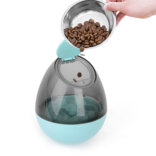 Orange and blue interactive pet food dispenser toy with multiple tiers and white balls, next to its black packaging. - Image 9