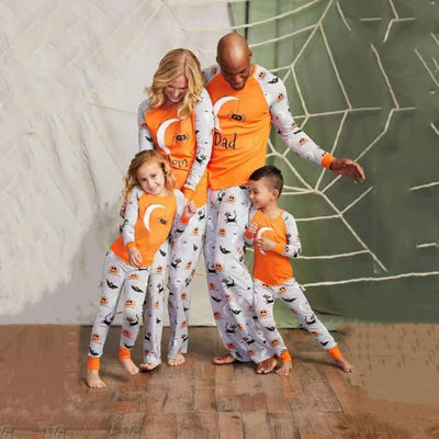 Matching family Halloween pajamas with orange and grey long-sleeve shirts and pants, featuring ghosts, pumpkins, and bats.