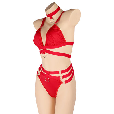 Woman wearing a royal blue strappy lingerie set with O-rings, including a bra, high-waisted bottoms, and a choker. - Image 24