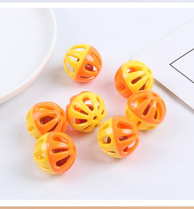 Five colorful plastic pet bell balls in red, yellow/orange, lime green, and hot pink, with hollow designs. - Image 9