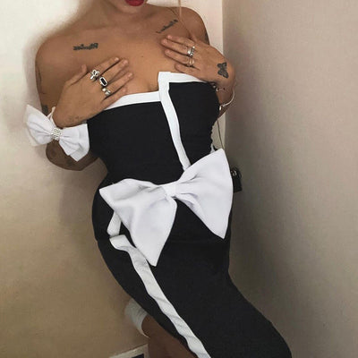 Black and white color-block one-piece swimsuit with an irregular tube top and a large white bow, paired with a matching pencil skirt. - Image 7