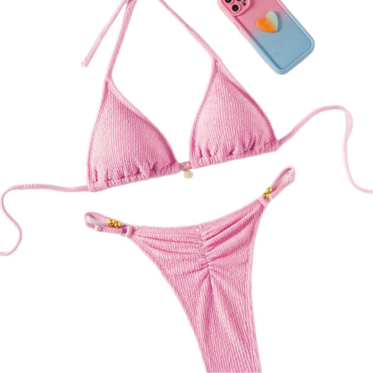 Pink textured halter bikini swimsuit with gold beads and a shell charm, worn by a woman on a wooden surface. - Image 5