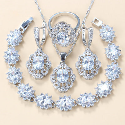 Four-piece jewelry set with silver-tone settings, featuring oval purple cubic zirconia stones surrounded by clear accents. - Image 9