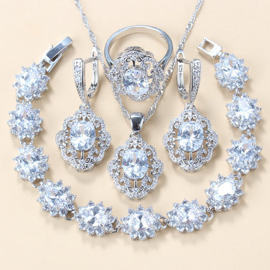 Four-piece jewelry set with silver-tone settings, featuring oval purple cubic zirconia stones surrounded by clear accents. - Image 9