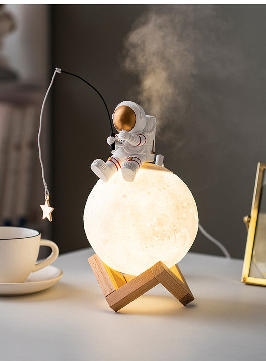 Astronaut figurine sitting on a glowing moon lamp, holding a fishing rod with a star charm, on a wooden stand. - Image 10
