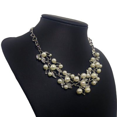 Gold-toned necklace and matching earrings set with faux pearls and clear rhinestones in an elegant leaf and vine design. - Image 7