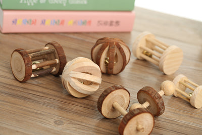 Set of natural wooden hamster toys including dumbbell shapes, a spherical bell toy, and two cylindrical bell toys, with a hamster. - Image 9