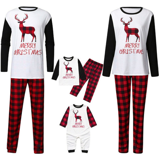 Family matching Christmas pajamas with red and black buffalo plaid pants and white long-sleeve tops featuring a deer graphic and "MERRY CHRISTMAS" text. Include