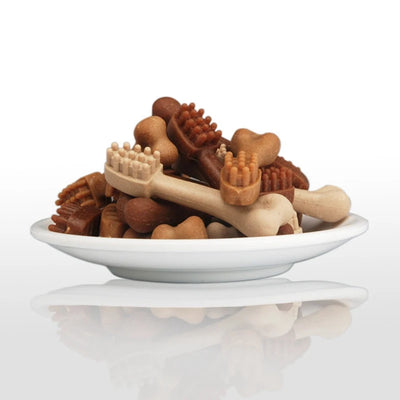 YaHo bone-shaped dog snacks in various brown and tan shades, some with dental nubs, in a black bowl. - Image 8