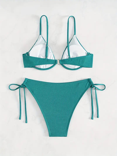 Black ribbed two-piece bikini with an underwire top and tie-side bottoms on a white marble surface. - Image 26