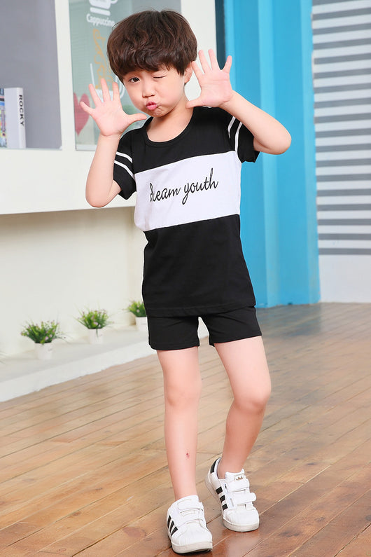 Young girl in a white short-sleeve t-shirt with a black stripe and black shorts, wearing a black cap. - Image 25