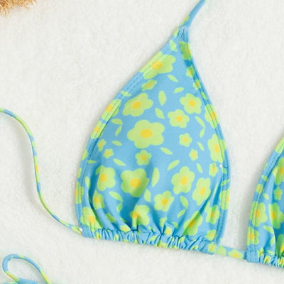 Lace-up sexy bikini with light blue and yellow floral print, featuring a triangle top and string tie bottoms. - Image 3