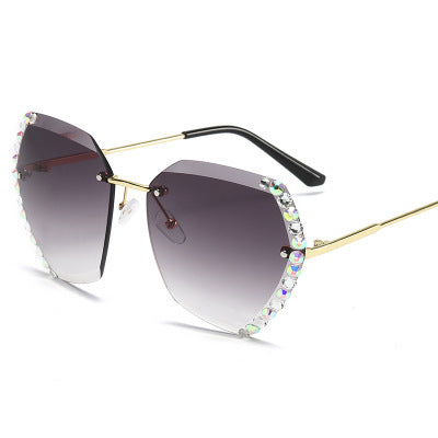Women's rimless sunglasses with gradient gray lenses, gold-tone metal arms, and iridescent rhinestone embellishments. - Image 7