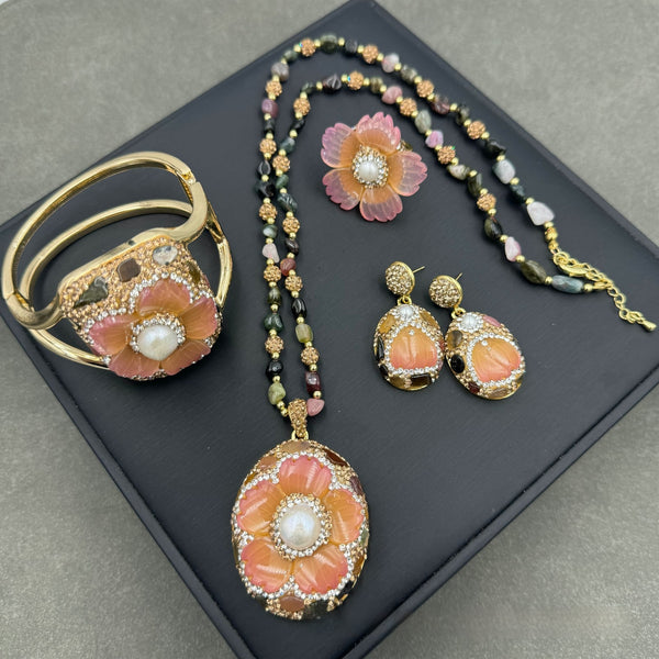 Gold-toned dangle earrings with oval drops, featuring a carved pink flower, clear rhinestones, and multi-colored tourmaline.