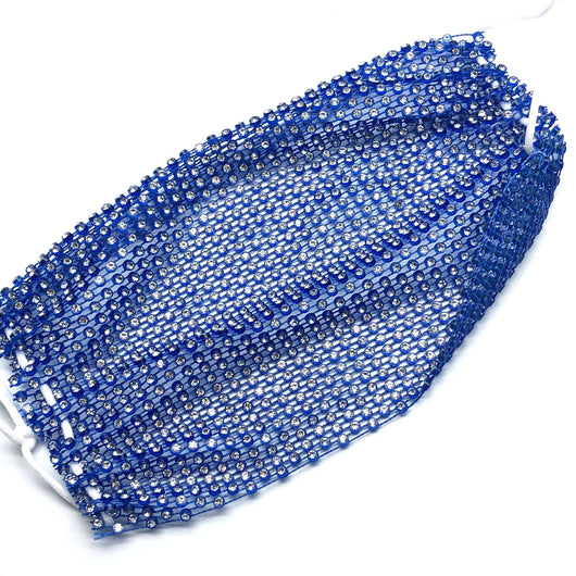 Close-up of a blue mesh fabric adorned with numerous small, clear rhinestones, creating a sparkling texture. - Image 46