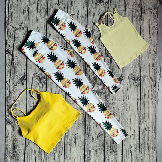 White parent-child yoga suit with tropical leaf print leggings and matching sleeveless tops.