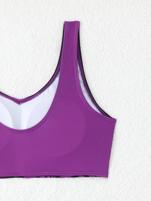Women's two-piece swimsuit with black and purple floral print. Features a V-neck sports bra top and mid-rise bottom. - Image 15