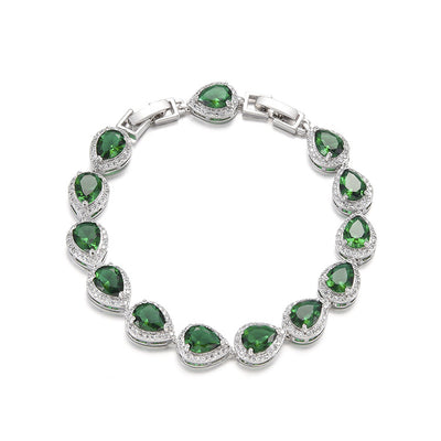 Green pear-shaped gemstone jewelry set with necklace, dangle earrings, ring, and bracelet, all with clear stone accents. - Image 2