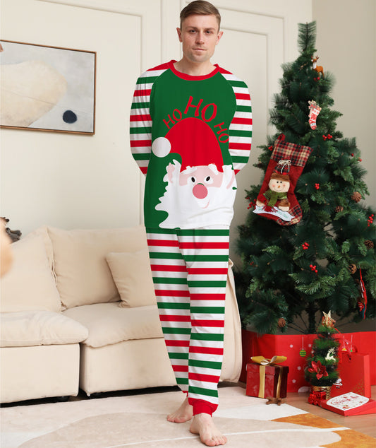 Woman wearing a green, red, and white striped Christmas pajama set with a Santa Claus graphic on the top. - Image 2