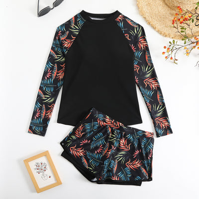 Women's long-sleeve tankini swimsuit with black top and blue tropical leaf print raglan sleeves, matching swim shorts. - Image 18