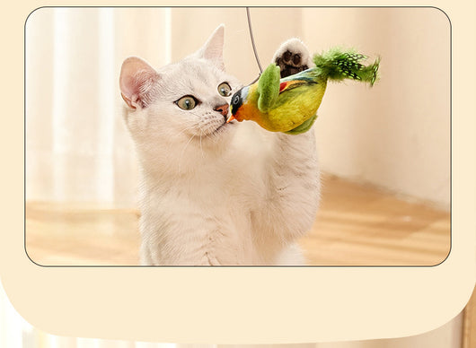 Colorful bird cat toy with green fluffy wings, black head, yellow face, orange beak, and spotted tail feathers. - Image 25
