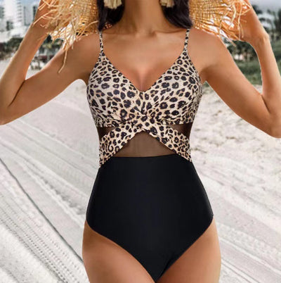 Woman in a green halter-neck one-piece swimsuit with cross-strap design and mesh cutouts, on a beach. - Image 10