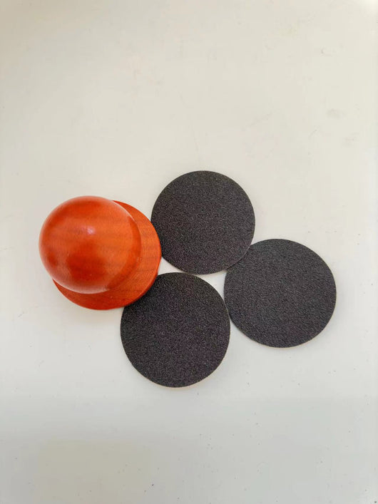 Red wooden dog claw grinding tool with a spherical handle and three circular black abrasive sanding pads. - Image 12