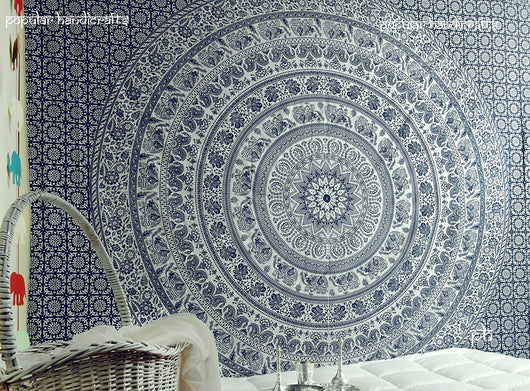Gold and blue mandala tapestry with elephant and floral patterns, hung above a white quilted bed. - Image 10