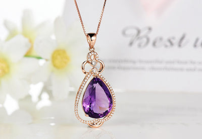 Rose gold necklace with a teardrop purple gemstone pendant and matching dangle earrings. - Image 12