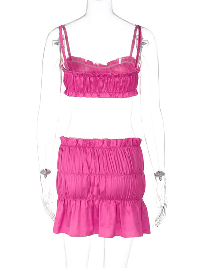 Fuchsia ruched tube top and matching pleated mini skirt set on a woman, perfect for summer. - Image 13
