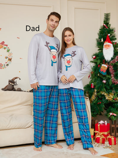 Young girl wearing a grey long-sleeve pajama top with a cartoon reindeer and blue plaid pajama pants. - Image 6
