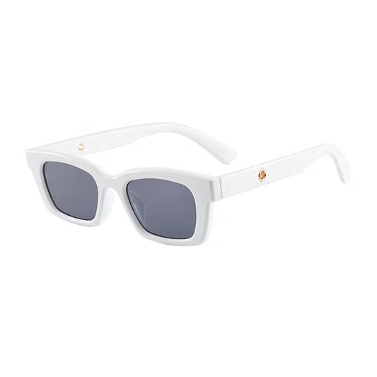 Transparent gray frame sunglasses with dark gray rectangular lenses and small gold accents on the temples.