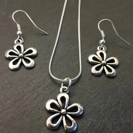 Silver-colored snake chain necklace with a delicate flower pendant and an adjustable lobster clasp closure. - Image 7