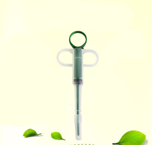 Pet feeding kit with a green syringe-style feeder and two clear teats, packaged for dogs and cats. - Image 2