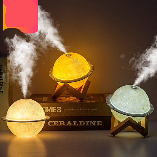 White moon-shaped humidifier with a textured surface resembling craters and a thin ring around its middle. - Image 9