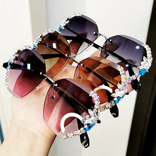 Oversized rimless sunglasses with gradient gray lenses and colorful rhinestone embellishments along the top and sides.