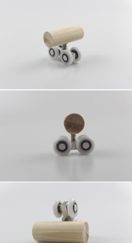 Wooden bird toy resembling a roller skate with a pine log body and four white wheels with metal bearings. - Image 9