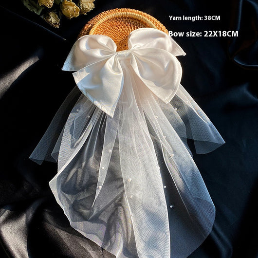 White birdcage veil with a cream satin bow and faux pearls, attached to a woven straw base, 80cm yarn length. - Image 14