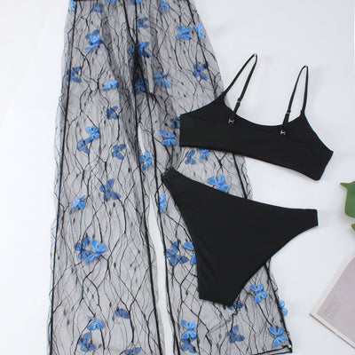 Women's black bikini three-piece set with a spaghetti strap top, matching bottoms, and sheer voile pants with blue butterfly appliques. - Image 2