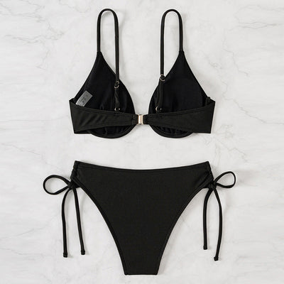 Black ribbed two-piece bikini with an underwire top and tie-side bottoms on a white marble surface. - Image 4