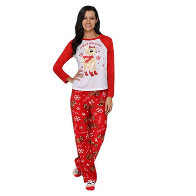 Family of five and a dog wearing matching red and white Christmas pajamas with reindeer and snowflake prints. - Image 3
