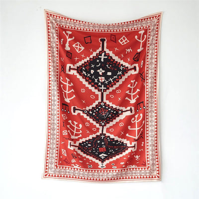 Red tapestry with black and white geometric tribal pattern hanging on a white wall above decorative pillows. - Image 3