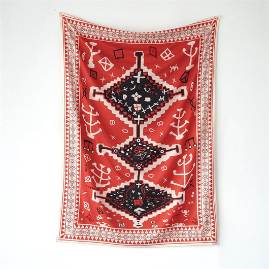 Red tapestry with black and white geometric tribal pattern hanging on a white wall above decorative pillows. - Image 3