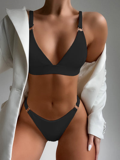 Coral ribbed two-piece bikini with triangle top and O-ring detail on straps and sides, worn by a woman. - Image 2